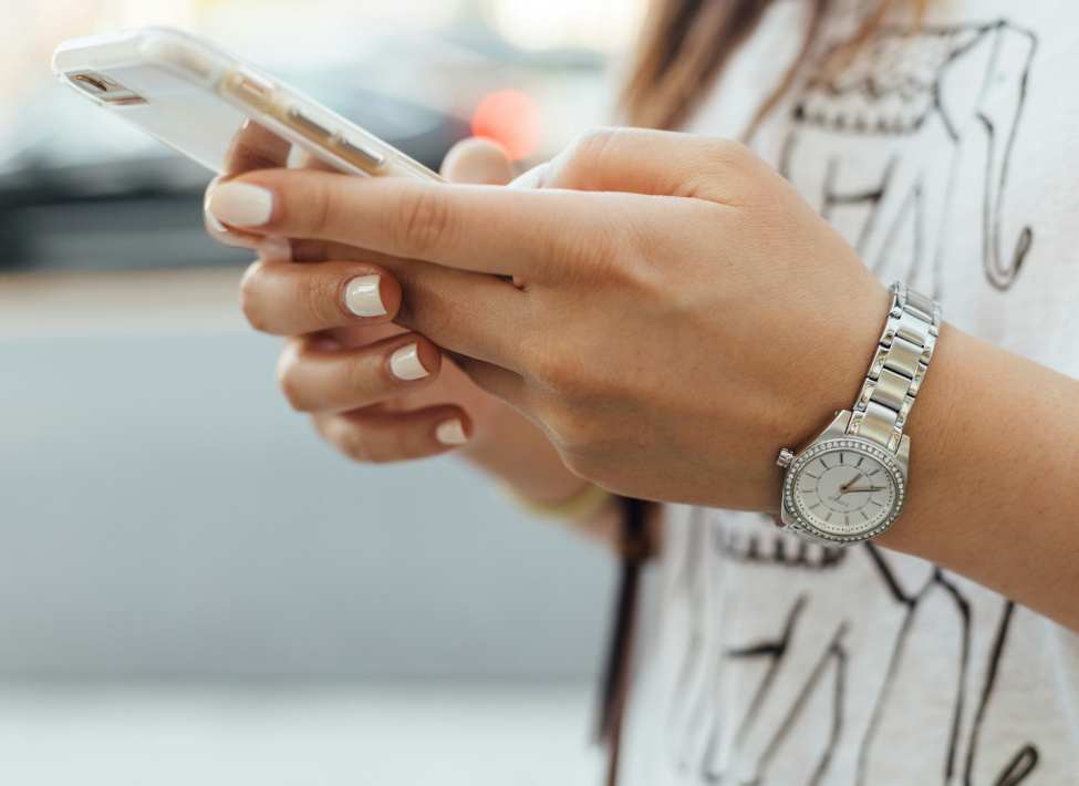A woman writing on her smartphone