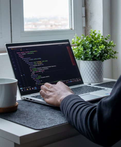 A man writing code on a computer