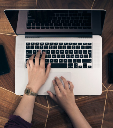 A person writing on a computer