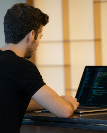 A man writing code on a computer